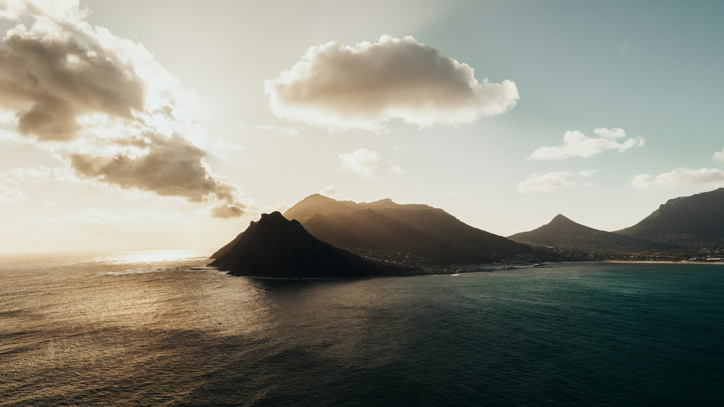 Dusk over Hout Bay and the Sentinel on the Cape Peninsula, with dark water in the foreground